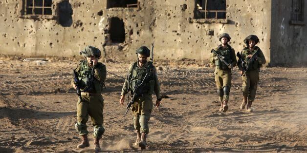Israeli soldiers take part in a military exercise, which includes infantry, tanks and artillery units, in the northern part of the Israeli-annexed Golan Heights near the border with Syria on June 23, 2016. / AFP / MENAHEM KAHANA (Photo credit should read MENAHEM KAHANA/AFP/Getty Images)