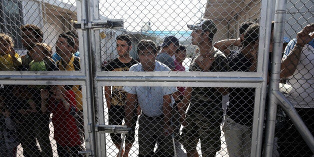 Refugees and migrants wait to be registered at the refugee camp near the village of Moria, on the Greek island of Lesbos, September 13, 2015. REUTERS/Alkis Konstantinidis/File Photo