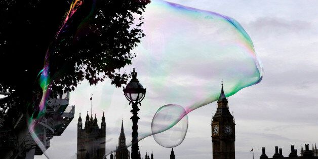 A giant soap bubble floats past the Houses of Parliament in central London October 29, 2012. REUTERS/Stefan Wermuth (BRITAIN - Tags: SOCIETY POLITICS CITYSPACE)