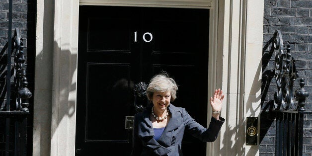 Britain's Home Secretary Theresa May waves to the media as she leaves after attending a cabinet meeting at 10 Downing Street,
