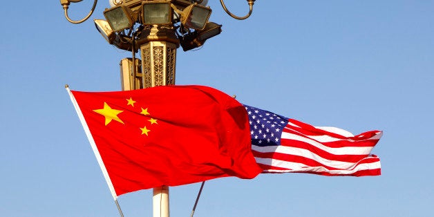 Flags of the People's Republic of China and the United States flutter jontly at lamp post of Tiananmen Square, State visit by President Bush, November 2005, Beijing China