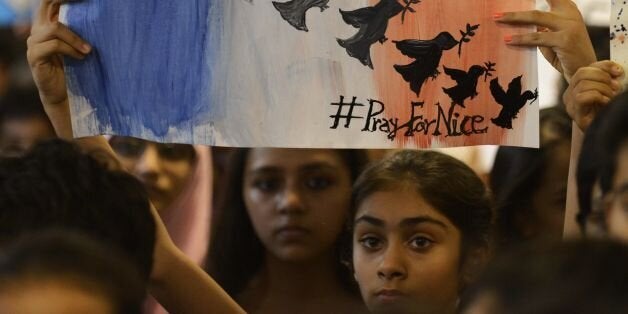 Indian students take part in a prayer meeting in memory of the victims of a truck attack in the French city of Nice at the Mahatma Gandhi International School (MGIS) in Ahmedabad on July 15, 2016. French President Francois Hollande said July 15 that 'many foreigners and young children' were among those killed or injured after the truck attack on a crowd celebrating Bastille Day in Nice, with around 50 fighting for their lives. At least 84 people were killed after a lorry ploughed into crowds celebrating Bastille Day in Nice. / AFP / SAM PANTHAKY (Photo credit should read SAM PANTHAKY/AFP/Getty Images)