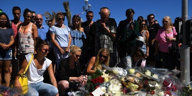 NICE, FRANCE - JULY 15: People visit the scene and lay tributes to the victims of a terror attack on the Promenade des Anglais on July 15, 2016 in Nice, France. A French-Tunisian attacker killed 84 people as he drove a lorry through crowds, gathered to watch a firework display during Bastille Day Celebrations. The attacker then opened fire on people in the crowd before being shot dead by police. (Photo by David Ramos/Getty Images)