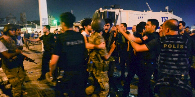 Turkish soldiers, arrested by civilians, are handed to police officers in Taksim Square in Istanbul, Turkey, early Saturday, July 16, 2016. Turkish President Recep Tayyip Erdogan told the nation Saturday that his government was working to crush a coup attempt after a night of explosions, air battles and gunfire across the Turkish capital of Ankara. (AP Photo/Selcuk Samiloglu)