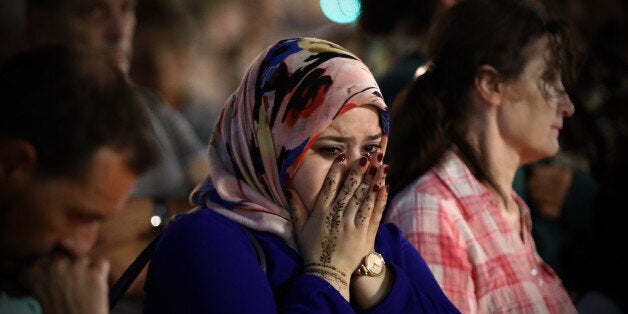 NICE, FRANCE - JULY 16: A woman weeps as she views flowers and tributes on the Promenade des Anglais on July 16, 2016 in Nice, France. Five people believed to be linked to the man who killed 84 people in Nice are in police custody according to a statement by the Paris prosecutor's office after a French-Tunisian attacker killed 84 people as he drove a lorry through crowds who had gathered to watch a firework display during Bastille Day Celebrations. The attacker then opened fire on people in the crowd before being shot dead by police. (Photo by Carl Court/Getty Images)