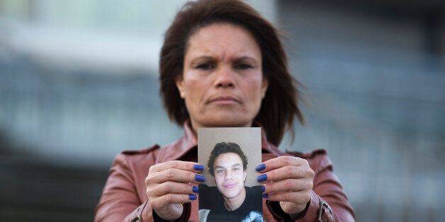 Ozana Rodrigues, the mother of Brian De Mulder, who left for Syria after being indoctrinated by Islamist group Sharia4Belgium, poses with a photo of her son outside the Antwerp courthouse, where the trial of the group is currently taking place, January 29, 2015. As Belgium braces for a verdict in Europe's biggest trial of those accused of fostering Islamist violence in Syria, much attention is on poor Muslim immigrant communities' struggle in a region blighted by youth unemployment. But for parents in Antwerp, a city on high alert since the Charlie Hebdo massacre in Paris and police raids on Belgian jihadists, the ruling on February 11 by judges there may never explain why their two sporty teenagers, with no Muslim heritage, abandoned comfortable homes to take up arms in the Middle East. And whatever sentences may be passed on their sons, Brian De Mulder's mother and Jejoen Bontinck's father both say the damage done by those who recruited them - harm that includes lost jobs and disrupted homes for parents and siblings - cannot be undone. Picture taken on January 29, 2015. REUTERS/Yves Herman (BELGIUM - Tags: CRIME LAW CONFLICT CIVIL UNREST POLITICS RELIGION)