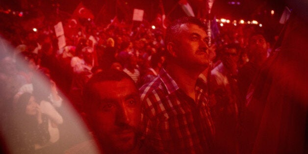 ISTANBUL, TURKEY - JULY 19: Supporters of Turkish President Recep Tayyip Erdogan attend a rally in Taksim Square on July 19, 2016 in Istanbul, Turkey. Clean up operations are continuing in the aftermath of Friday's failed military coup attempt. Latest figures according to Turkey's Prime Minister Binali Yildirim raises the death toll to 208 with 1491 wounded. Continuing raids across the country have seen 7543 people detained and 316 arrested including high ranking soldiers, judges and police officers. (Photo by Chris McGrath/Getty Images)