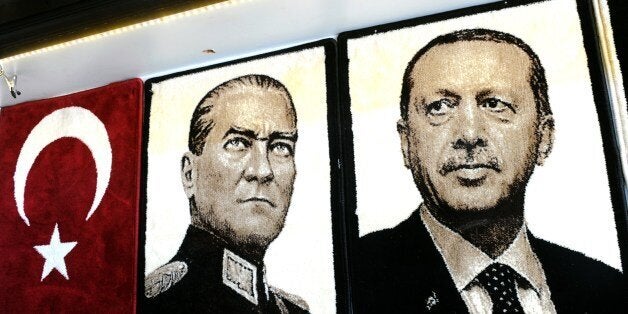 Embroidered images of the founder of modern Turkey Mustafa Kemal Ataturk (L) and Turkey's Prime Minister Recep Tayyip Erdogan (R) are displayed in a shop in the Gaziantep market on January 17, 2014 in Gaziantep, near the Turkish-Syrian border. AFP PHOTO / OZAN KOSE (Photo credit should read OZAN KOSE/AFP/Getty Images)