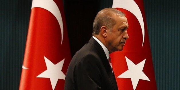 Turkish President Tayyip Erdogan leaves after a news conference following the National Security Council and cabinet meetings
