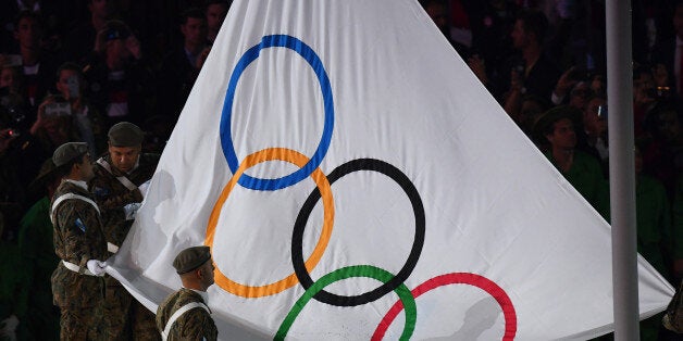 The Olympic flag is raised during the opening ceremony of the Rio 2016 Olympic Games at the Maracana stadium in Rio de Janeiro on August 5, 2016. / AFP / GABRIEL BOUYS (Photo credit should read GABRIEL BOUYS/AFP/Getty Images)