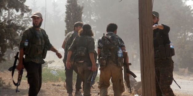 Fighters from the former Al-Nusra Front -- renamed Fateh al-Sham Front after breaking from Al-Qaeda -- advance at an armament