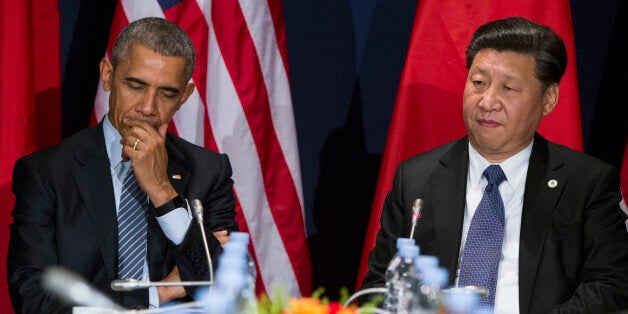 U.S. President Barack Obama, left, meets with Chinese President Xi Jinping during their meeting held on the sidelines of the COP21, United Nations Climate Change Conference, in Le Bourget, outside Paris, Monday, Nov. 30, 2015. (AP Photo/Evan Vucci)