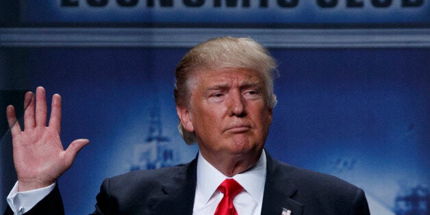 Republican presidential candidate Donald Trump waves after delivering an economic policy speech to the Detroit Economic Club,