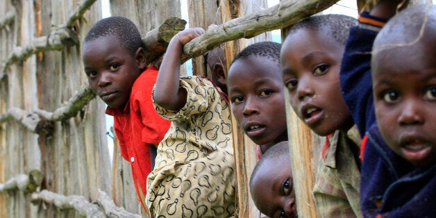 Congolese refugee children play on wooden fencing erected to secure the Nyakabande refugees transit camp in Kisoro district, 491 km (305 miles) west of Ugandan capital Kampala November 9, 2013. REUTERS/James Akena (UGANDA - Tags: SOCIETY IMMIGRATION POVERTY TPX IMAGES OF THE DAY CIVIL UNREST)