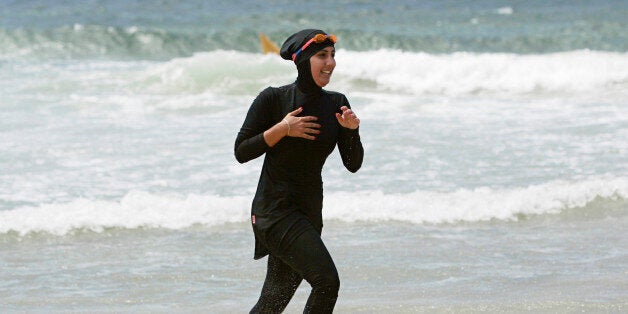 Twenty-year-old trainee volunteer surf life saver Mecca Laalaa runs along North Cronulla Beach in Sydney during her Bronze medallion competency test January 13, 2007. Specifically designed for Muslim women, Laalaa's body-covering swimming costume has been named the "burkini" by its Sydney based designer Aheda Zanetti. REUTERS/Tim Wimborne (AUSTRALIA)