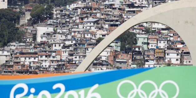 The favela San Carlos is pictured from the finish area of the Women's Marathon during the athletics event at the Rio 2016 Olympic Games at Sambodromo in Rio de Janeiro on August 14, 2016. / AFP / Adrian DENNIS (Photo credit should read ADRIAN DENNIS/AFP/Getty Images)