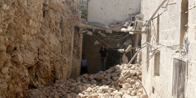 Residents inspect their damaged homes after an airstrike on the rebel-held Old Aleppo, Syria August 15, 2016. REUTERS/Abdalrh