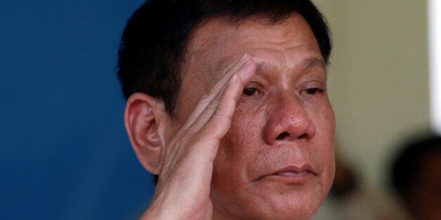 Philippines' President Rodrigo Duterte salutes during a military parade at main military Camp Aguinaldo in Quezon city Metro