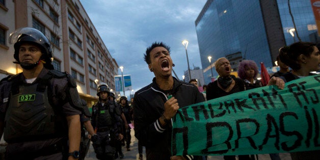 Students protest against the money spent on the Rio 2016 Olympics in Rio de Janeiro, Brazil, Sunday, Aug. 21, 2016. Demonstra