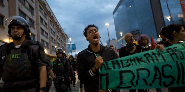 Students protest against the money spent on the Rio 2016 Olympics in Rio de Janeiro, Brazil, Sunday, Aug. 21, 2016. Demonstrators are demanding answers about what will be the legacy the Rio 2016 summer games for the poor, security and education. (AP Photo/Silvia Izquierdo)