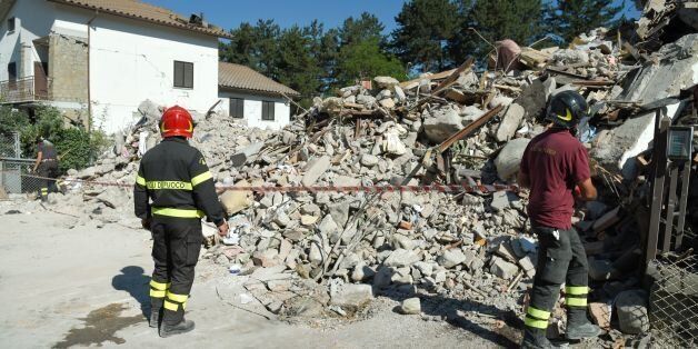 Firefighters mark out a security cordon around rubble and debris of a destroyed building in the damaged central Italian village of Amatrice on August 26, 2016 two day after a 6.2-magnitude earthquake struck the region killing some 267 people.An increasingly forlorn search for victims of the earthquake that brought carnage to central Italy entered a third day on August 26, 2016 as the confirmed death toll climbed to 267. At least 367 people have been hospitalised with injuries but no one has been pulled alive from the piles of collapsed masonry since August 24, 2016 evening. / AFP / ANDREAS SOLARO (Photo credit should read ANDREAS SOLARO/AFP/Getty Images)