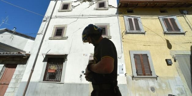 A firefighter walks in the hamlet of Torrita in Amatrice, on August 29, 2016, few days after an earthquake hit the area, a di