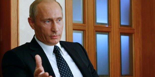 Russian Prime Minister Vladmir Putin gestures speaking during his interview to French daily Le Figaro in Sochi on Russia's Bl