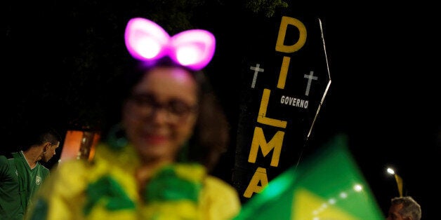 A pro-impeachment demonstrator holds a cardboard coffin painted with the name of Brazil's suspended president Dilma Rousseff