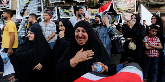 A woman mourns at a makeshift shrine for victims of the Karrada suicide bomb attack at the site where the incident took place in Baghdad, Iraq July 10, 2016. Picture taken July 10, 2016. REUTERS/Ahmed Saad