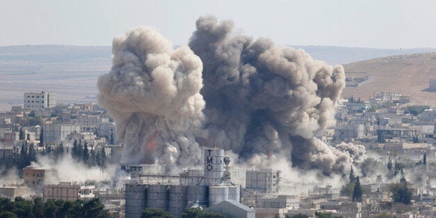 Smoke rises after an U.S.-led air strike in the Syrian town of Kobani Ocotber 8, 2014. U.S.-led air strikes on Wednesday pushed Islamic State fighters back to the edges of the Syrian Kurdish border town of Kobani, which they had appeared set to seize after a three-week assault, local officials said. The town has become the focus of international attention since the Islamists' advance drove 180,000 of the area's mostly Kurdish inhabitants to flee into adjoining Turkey, which has infuriated its own restive Kurdish minority-- and its NATO partners in Washington -- by refusing to intervene. REUTERS/Umit Bektas (SYRIA - Tags: POLITICS CONFLICT TPX IMAGES OF THE DAY)