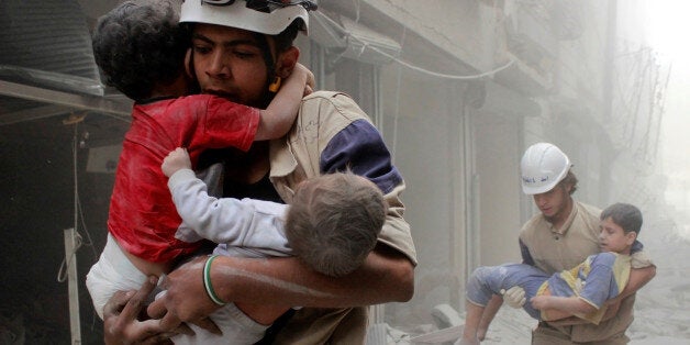 Members of the Civil Defence rescue children after what activists said was an air strike by forces loyal to Syria's President