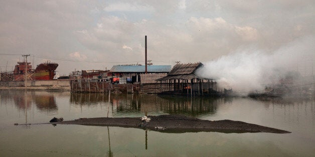 Every day these factories release smoke around it in Dhaka, Bangladesh, on 22 August 2016. People from the southern part of Bangladesh are the victims of climate change. The climate change results in making them to move to the capital Dhaka. These migrated people work in factories which are polluting the environment. Many factories produce smoke containing toxic chemicals which may cause breathing problem. They also release chemicals in the nearest river or pond. Migrated workers work for 24 hours a day and 15 days in a month. They hardly get chance to visit their relatives in village. Working under this circumstance they get asthma or other breathing problems. They do not have any safe protection from the gas or dust. (Photo by Mushfiqul Alam/NurPhoto via Getty Images)