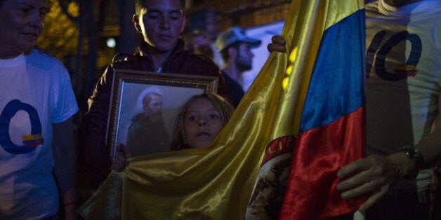 People react after learning about the rejection of a peace deal with the Revolutionary Armed Forces of Colombia (FARC) following a plebiscite in Bogota, Colombia, on Sunday, Oct. 2, 2016. Colombian voters rejected a peace deal with FARC rebels, apparently saying 'no' to an accord in a shocking upset that risks renewing 52 years of war and is likely to rattle investors across Latin America. Photographer: Nicolo Filippo Rosso/Bloomberg via Getty Images