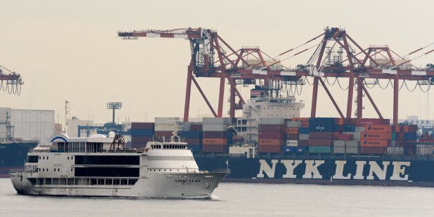A Nippon Yusen KK (NYK Line) container ship, background, sits berthed at a shipping terminal in Tokyo, Japan, on Monday, Oct. 31, 2016. Japan's three biggest shippers agreed to spin off their container operations and merge them to create the world's sixth-largest box carrier as the global container-shipping industry continues to shrink. Photographer: Akio Kon/Bloomberg via Getty Images