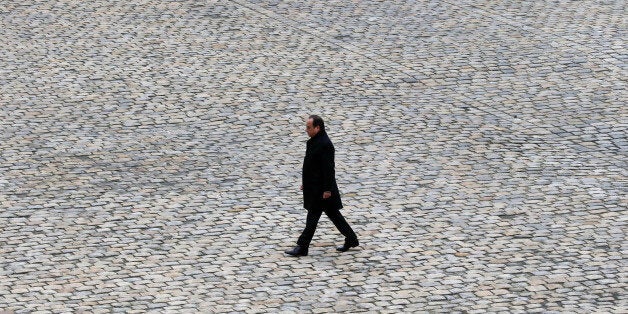 FILE - In this Friday, Nov. 27, 2015 file picture, French President Francois Hollande walks in the courtyard of the Invalides national monument during a ceremony in Paris, France. French President Francois Hollande says he decided against running for another term because he wants to give his Socialist party a chance to win "against conservatism and extremism." (AP Photo/Francois Mori, File)