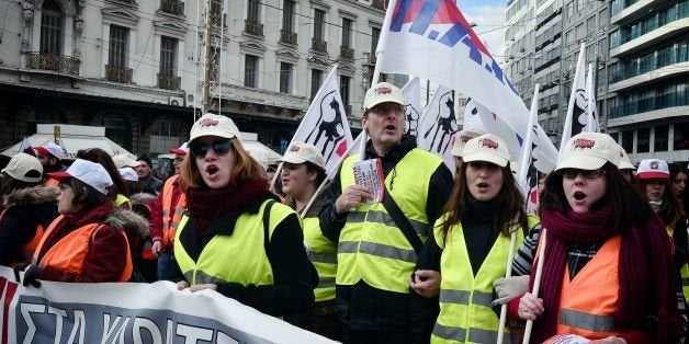 People take part in a rally marking a 24-hours general strike in Athens on December 8, 2016. Greece's leading unions launched a general strike that shut down several key sectors in protest over planned new pay cuts and taxes called for by international creditors. Civil servants, bank staff, merchant seamen, railway workers and state-employed doctors were among professionals taking part in the 24-hour stoppage against the measures, which are scheduled to be approved by lawmakers at the weekend. / AFP / LOUISA GOULIAMAKI (Photo credit should read LOUISA GOULIAMAKI/AFP/Getty Images)