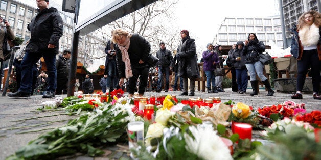 People gather to lay down flowers outside the Gedaechniskirche near the area where a truck which ploughed into a crowded Christmas market in the German capital last night in Berlin. REUTERS/Pawel Kopczynski