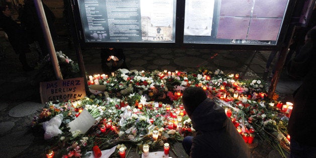 BERLIN, GERMANY - DECEMBER 20: People leave flowers and candles at the area after a lorry truck ploughed through a Christmas market on December 20, 2016 in Berlin, Germany. So far 12 people are confirmed dead and 45 injured. Authorities have confirmed they believe the incident was an attack and have arrested a Pakistani man who they believe was the driver of the truck and who had fled immediately after the attack. Among the dead are a Polish man who was found on the passenger seat of the truck. Police are investigating the possibility that the truck, which belongs to a Polish trucking company, was stolen yesterday morning. (Photo by Michele Tantussi/Getty Images)