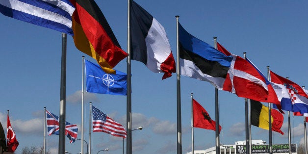 Flags fly at the Alliance headquarters in Brussels during a NATO ambassadors meeting on the situation in Ukraine and the Crimea region, March 2, 2014. Russia is threatening peace in European via its military actions in Ukraine and must immediately de-escalate tensions, NATO Secretary General Anders Fogh Rasmussen said on Sunday. REUTERS/Yves Herman (BELGIUM - Tags: POLITICS CONFLICT MILITARY)