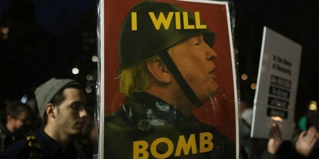 NEW YORK, UNITED STATES - JANUARY 25: Demonstrators hold banners during a rally against US President Donald Trump's order cracking down on immigrants in Washington Square Park in Manhattan borough of New York, USA on Jan. 25, 2017 as Council on American-Islamic Relations (CAIR) news conference continues. (Photo by Mohammed Elshamy/Anadolu Agency/Getty Images)