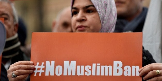 ROME, ITALY - FEBRUARY 02: A woman holds banner, reading '#NoMuslimBan' during a protest against US President Donald Trump and his policies outside the US Embassy in Rome, Italy on February 02, 2017. Protesters came out to demonstrate against a recent ban on travel, transit and immigration by people hailing from seven predominantly Muslim countries, enacted through an executive order by U.S. President Donald Trump. (Photo by Alvaro Padilla Bengola/Anadolu Agency/Getty Images)