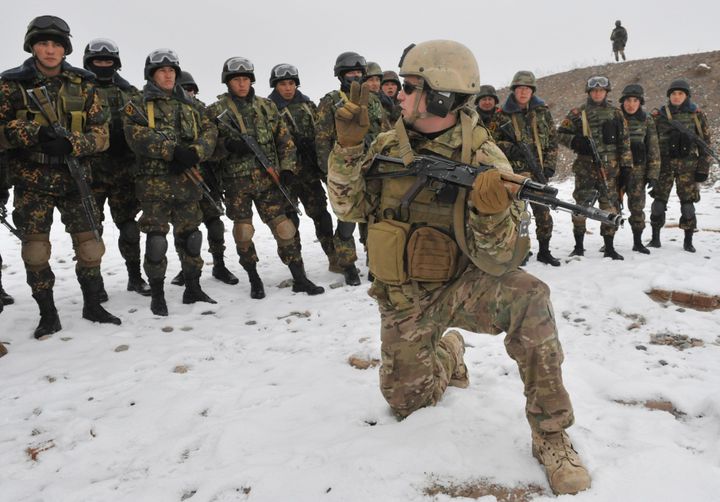 A US soldier from the 3rd Special Forces Group (foreground) demonstrates his skill to Kyrgyz soldiers from 'Scorpion' 'special forces during their joint anti-terrorist exercise at a firing range near the town of Tokmak, some 60 km from Bishkek on December 7, 2011. AFP PHOTO / VYACHESLAV OSELEDKO (Photo credit should read VYACHESLAV OSELEDKO/AFP/Getty Images)