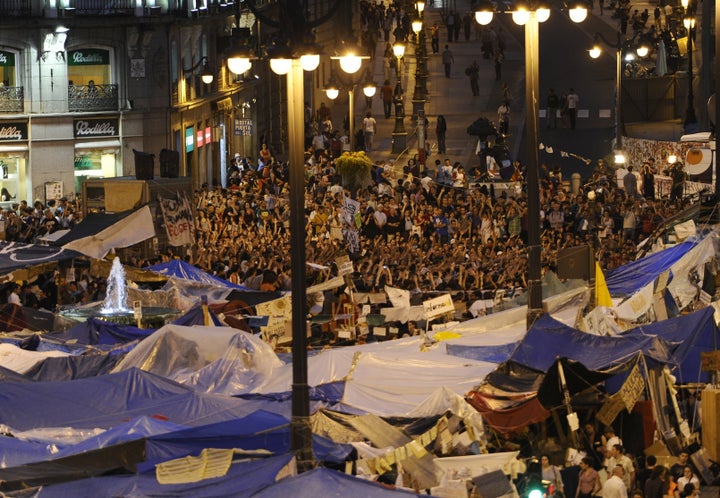 Protesters camp at the Puerta del Sol square in Madrid on May 26, 2011 during a demonstration against Spain's economic crisis and its sky-high jobless rate. Fired up with 60s-style idealism and fueled by online people power, the anti-crisis protesters who took Spain by storm hope they can be an example to the world. AFP PHOTO/ PIERRE-PHILIPPE MARCOU (Photo credit should read PIERRE-PHILIPPE MARCOU/AFP/Getty Images)