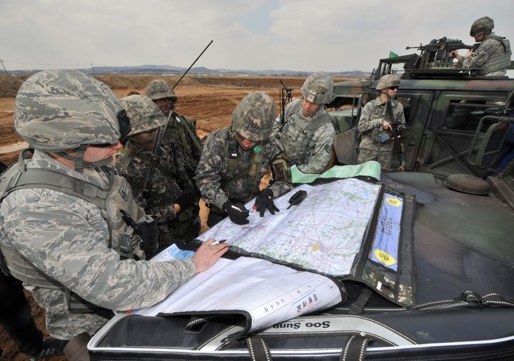 US Air Force and South Korean Army soldiers read maps for an operation to guard a US airbase as part of annual joint exercises outside the airbase in Pyeongtaek, south of Seoul, on March 14, 2013. The drill comes as North Korean leader Kim Jong-Un oversaw a live-fire artillery drill near the disputed sea border with South Korea, state media said on March 14 as the South's prime minister visited the flashpoint area. AFP PHOTO / JUNG YEON-JE (Photo credit should read JUNG YEON-JE/AFP/Getty Images)