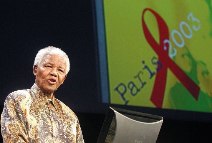 Former South African president Nelson Mandela gives a speech 14 July 2003 in Paris during the second day of an AIDS four-day conference. Noisy demonstrators demanding fund for HIV drugs in the developing world disrupted the conference here but in doing so gained the beaming support of Nelson Mandela. AFP PHOTO JEAN AYISSI (Photo credit should read JEAN AYISSI/AFP/Getty Images)