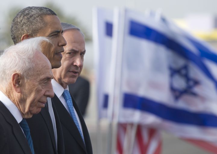 US President Barack Obama (C) stands alongside Israeli Prime Minister Benjamin Netanyahu (R) and Israeli President Shimon Peres prior to departing from Ben Gurion International Airport in Tel Aviv, Israel, on March 22, 2013. Following a three-day trip to Israel and the Palestinian territories, his first as president, Obama fly to Amman for talks and a private dinner with King Abdullah II, after wrapping up his trip to the Holy Land with a visit to Bethlehem's Church of the Nativity. AFP PHOTO / SAUL LOEB (Photo credit should read SAUL LOEB/AFP/Getty Images)