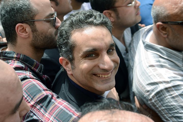 Egyptian satirist and television host Bassem Youssef is surrounded by his supporters upon his arrival at the public prosecutor's office in the high court in Cairo, on March 31, 2013. Egypt's public prosecutor ordered the arrest of popular satirist Youssef over alleged insults to Islam and to President Mohamed Morsi, in the latest clampdown on critical media. AFP PHOTO / KHALED DESOUKI (Photo credit should read KHALED DESOUKI/AFP/Getty Images)