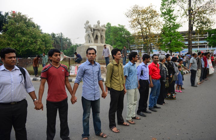 Bangladeshi bloggers form a human chain to protest against the detention of three bloggers at Dhaka University campus in Dhaka on April 2, 2013. Bangladesh police have arrested three atheist bloggers for allegedly defaming Islam and the Prophet Mohammed, police said, amid demands from religious fundamentalists for an internet crackdown. AFP PHOTO/Munir uz ZAMAN (Photo credit should read MUNIR UZ ZAMAN/AFP/Getty Images)