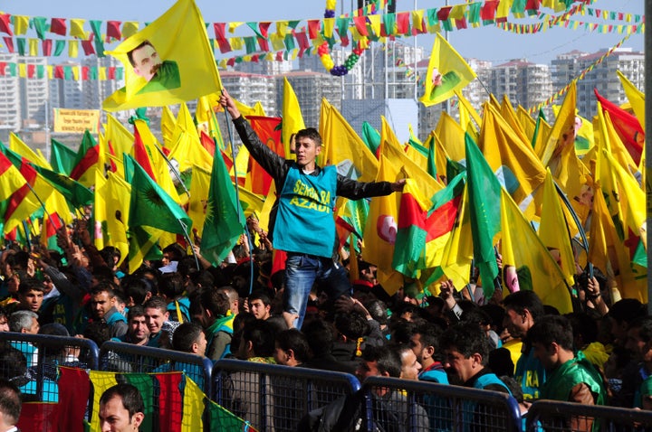 A Kurdish man waves a poster of founder of PKK (Kurdish Worker Party) Abdullah Ocalan during celebrations of Nowruz, the Persian New Year festival, on March 21, 2013 in Diyarbakir. Jailed Kurdish rebel chief Abdullah Ocalan was set to call a 'historic' ceasefire on Thursday, raising expectations for an end to a three-decade conflict with Turkey that has cost tens of thousands of lives. AFP PHOTO/STR (Photo credit should read -/AFP/Getty Images)