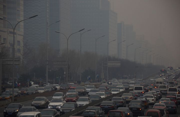 Traffic moves along a street shrouded in haze in Beijing, China, on Friday, March 15, 2013. China's new premier promised to crack down on corruption and clean up pollution, acknowledging the need to tackle two issues that have stoked public anger toward the country's leaders. Photographer: Tomohiro Ohsumi/Bloomberg via Getty Images